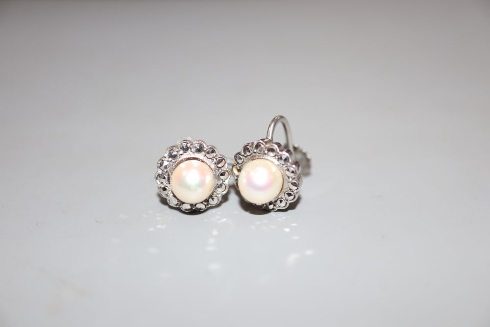 A pair of white metal (stamped silver) and cultured pearl set earclips, in a bright cut setting, 11mm, in Harrods box.